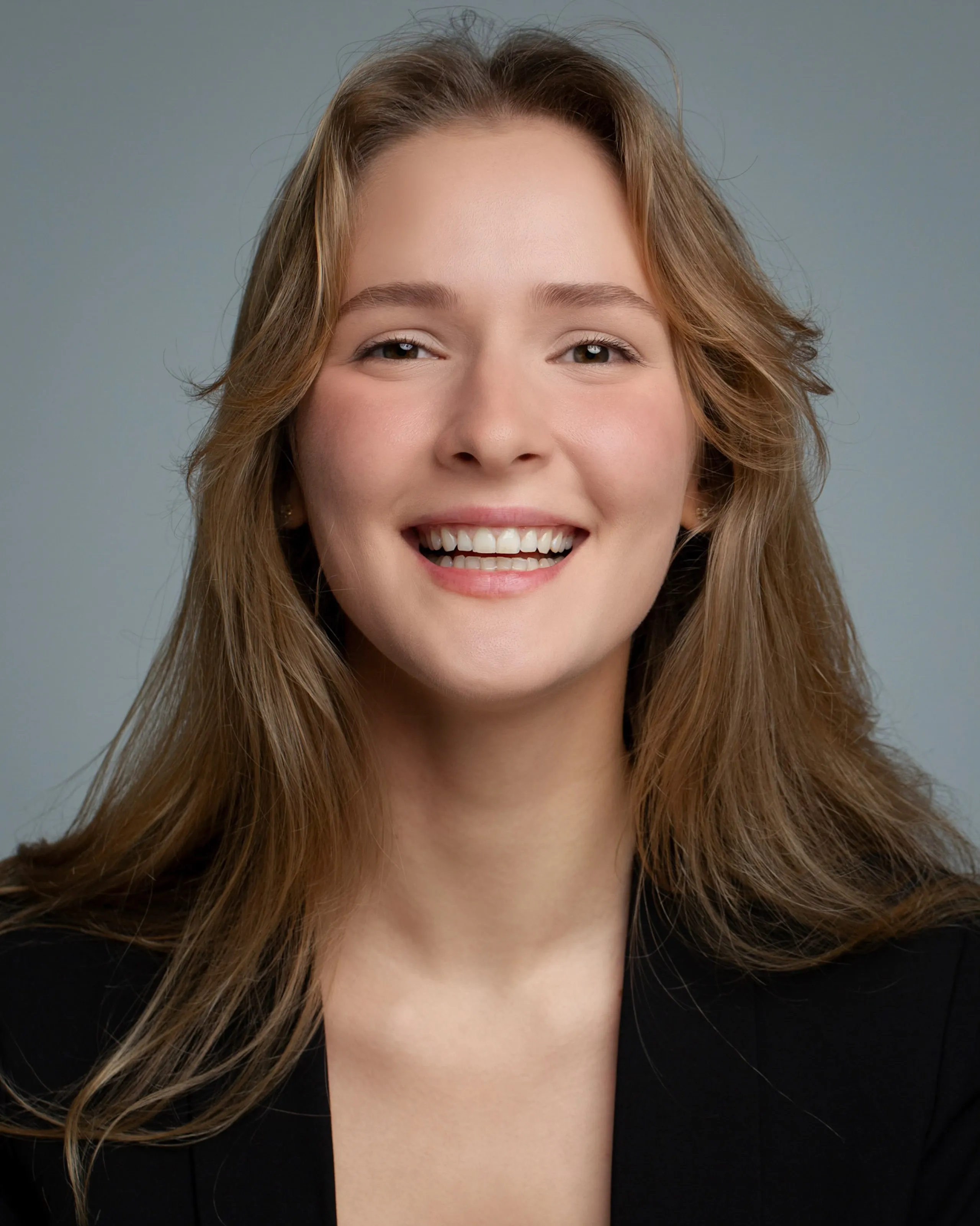 Mariia KO — studio headshot with a bright, open smile