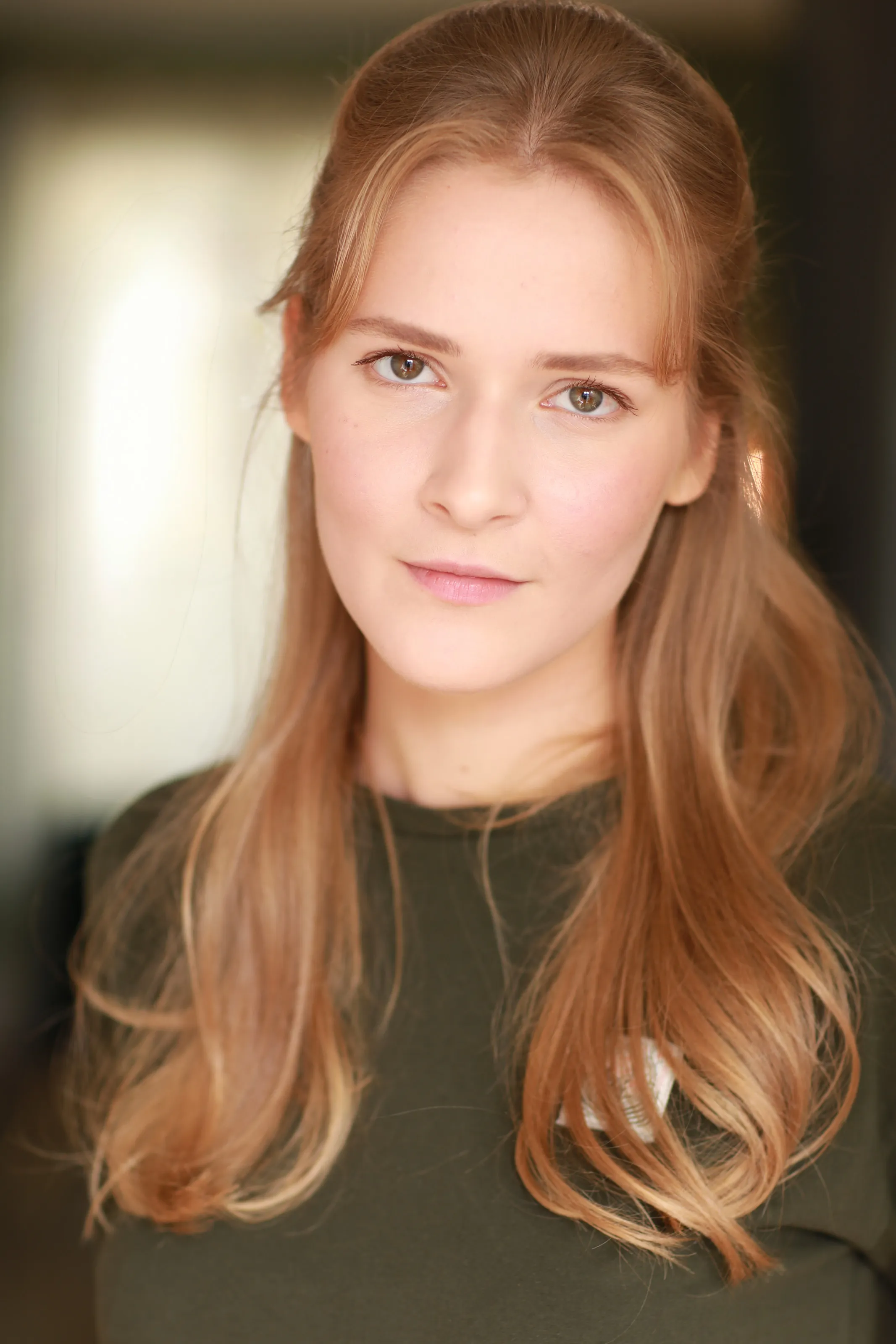 Mariia KO — natural-light headshot in an olive top