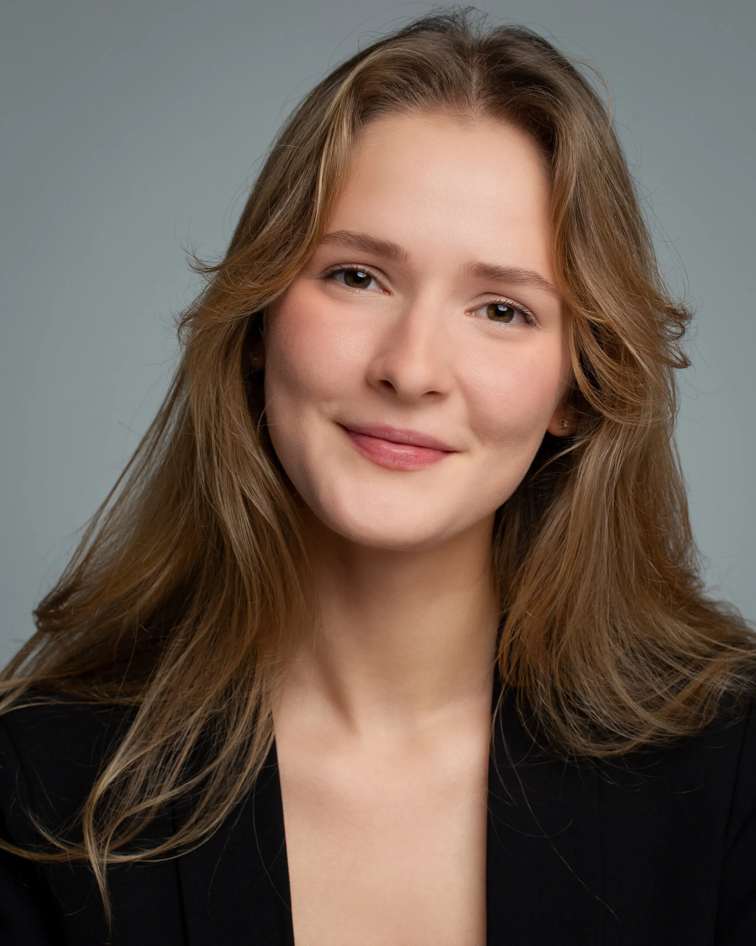 Mariia KO — studio headshot with a soft smile